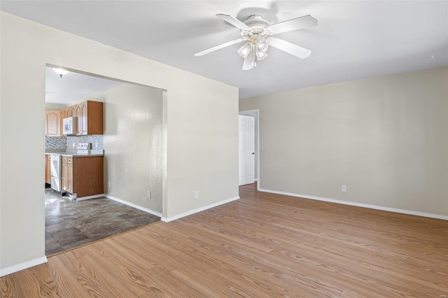 empty room with ceiling fan and light wood-type flooring