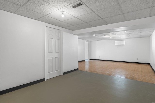 basement featuring a paneled ceiling