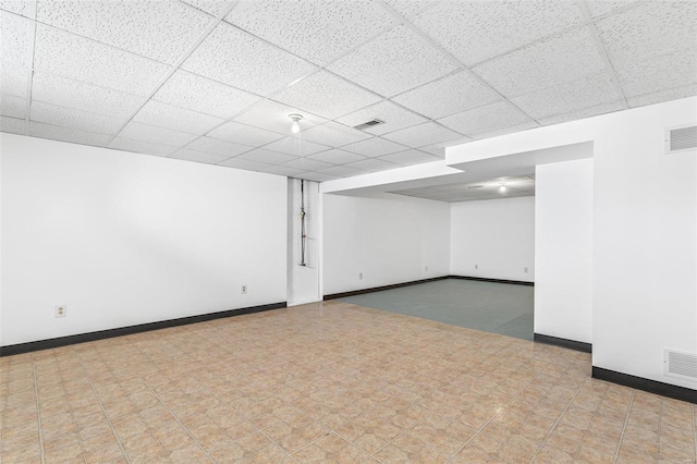 basement with a paneled ceiling