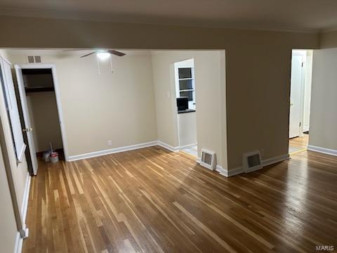 interior space featuring ornamental molding, dark hardwood / wood-style floors, and ceiling fan