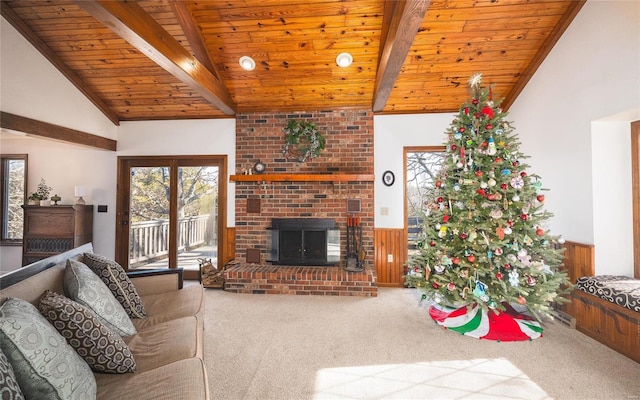 living room with carpet floors, wood ceiling, a fireplace, and lofted ceiling with beams