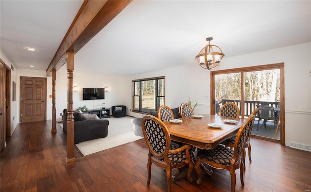 dining room with beam ceiling, dark hardwood / wood-style floors, and a chandelier