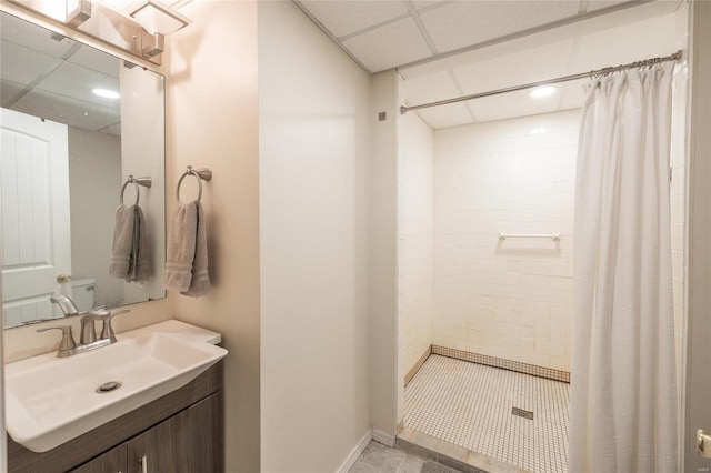 bathroom featuring vanity, a paneled ceiling, and curtained shower