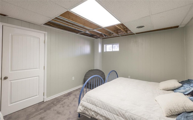 bedroom featuring a paneled ceiling and carpet