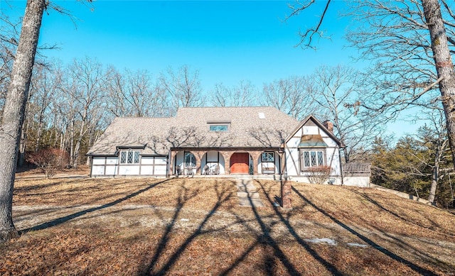 english style home with a front yard