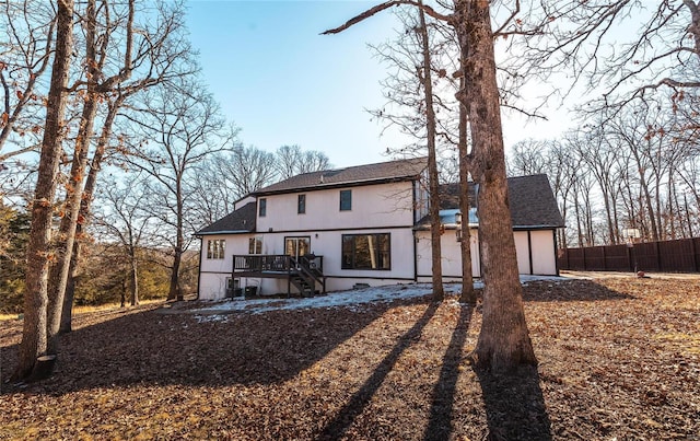 rear view of property featuring a wooden deck