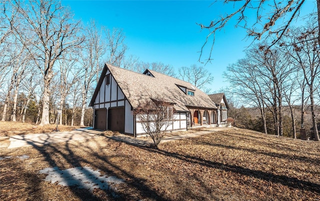 view of property exterior featuring a garage and a porch