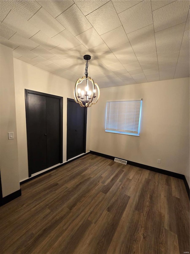 unfurnished bedroom with dark hardwood / wood-style flooring