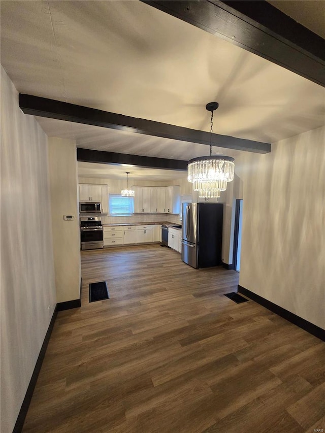 unfurnished dining area featuring beamed ceiling, dark hardwood / wood-style floors, and a chandelier