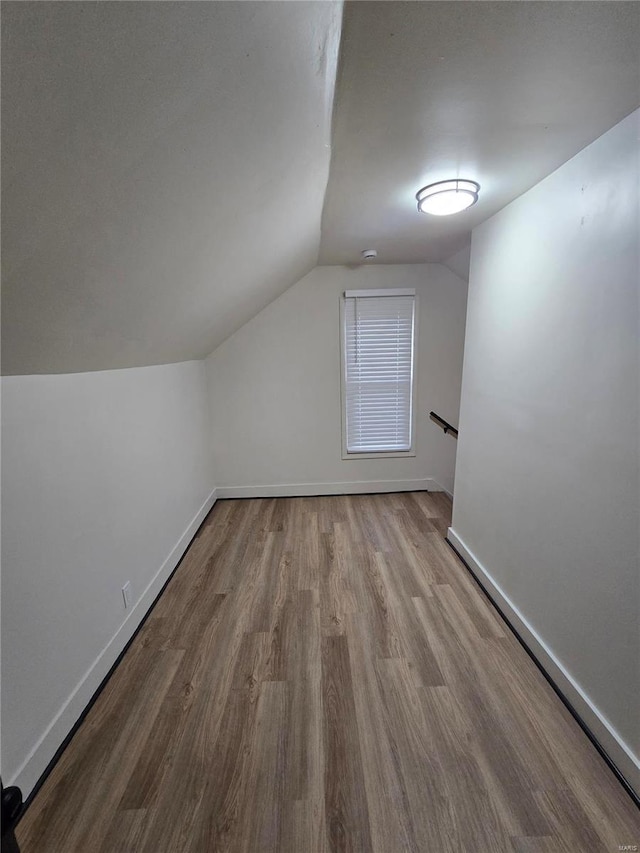 bonus room featuring lofted ceiling and light hardwood / wood-style floors