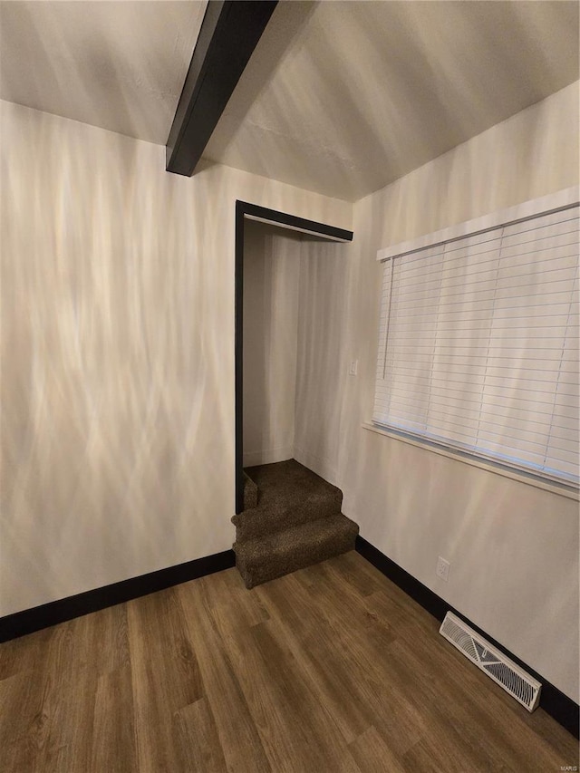 interior space with hardwood / wood-style flooring and beam ceiling