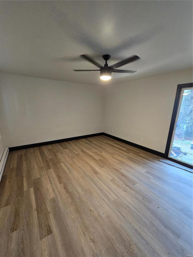 unfurnished room with a textured ceiling, light hardwood / wood-style floors, and ceiling fan