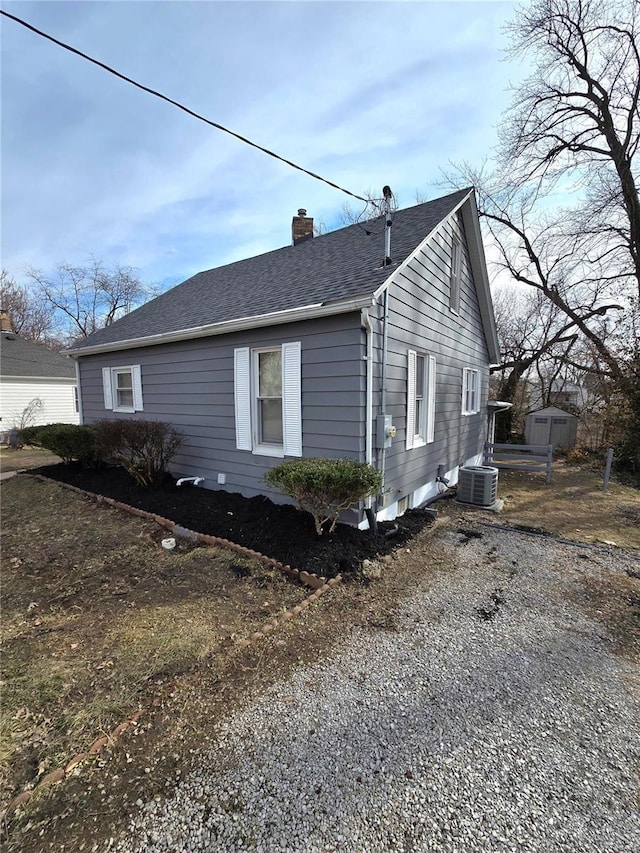 view of side of home with central AC unit