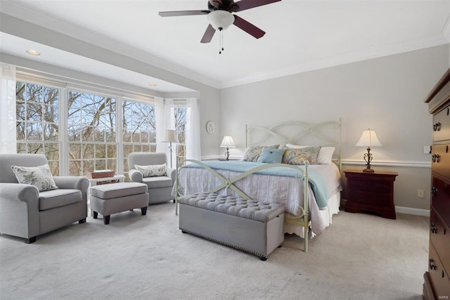 bedroom featuring ornamental molding, light colored carpet, and ceiling fan