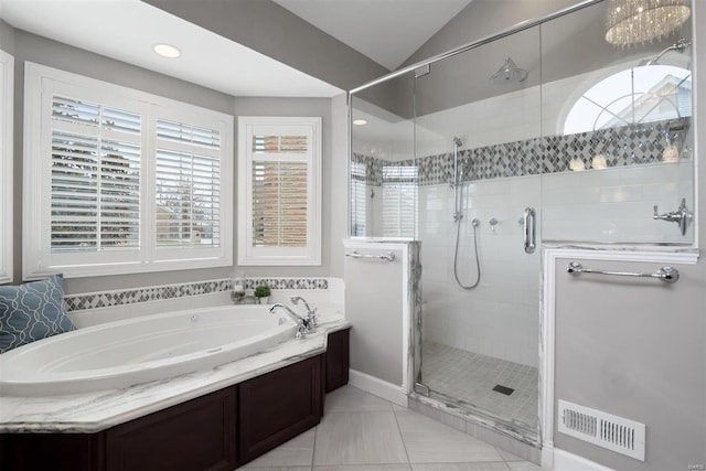 bathroom featuring lofted ceiling and independent shower and bath