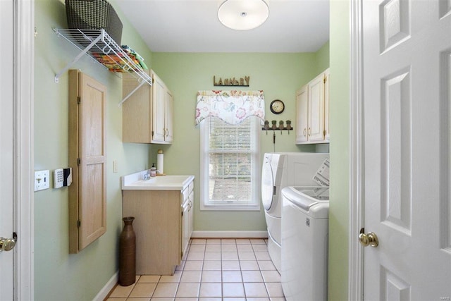 clothes washing area featuring cabinets, separate washer and dryer, sink, and light tile patterned floors