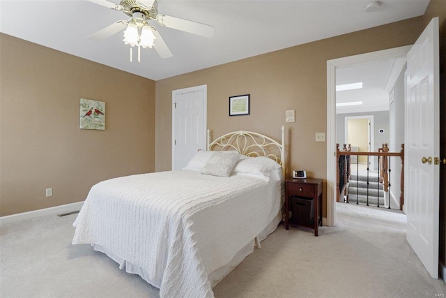 bedroom featuring ceiling fan and light colored carpet