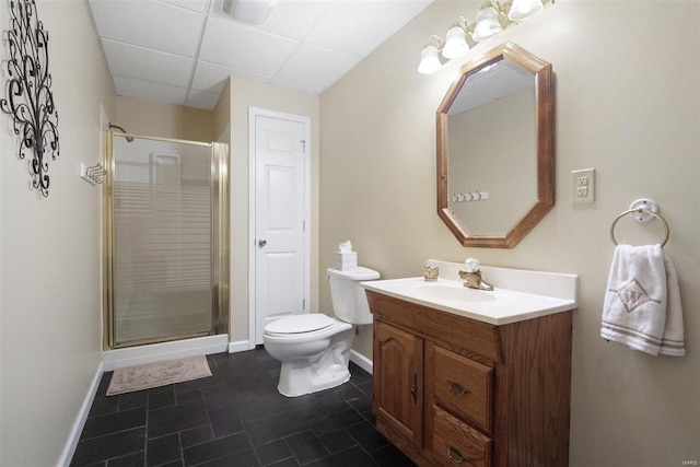 bathroom featuring vanity, a paneled ceiling, an enclosed shower, and toilet