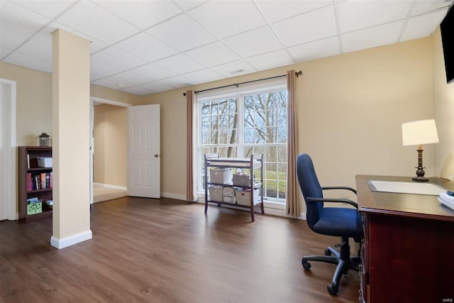 office with dark hardwood / wood-style floors and a paneled ceiling