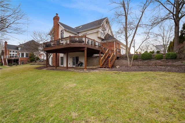 rear view of property featuring a wooden deck and a lawn