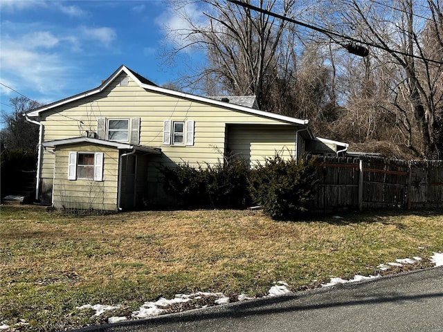 view of side of home featuring a lawn