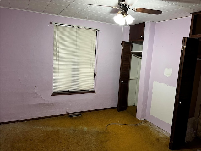 interior space featuring carpet floors and ceiling fan