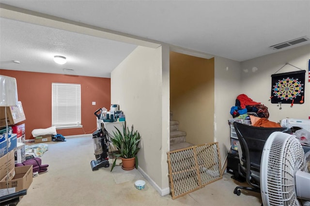 interior space featuring carpet floors and a textured ceiling