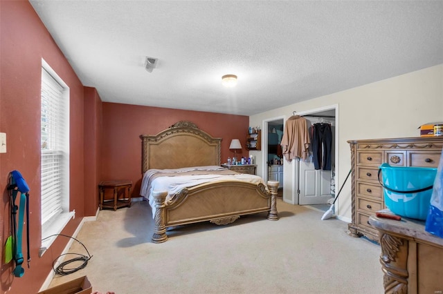 bedroom with light colored carpet, a closet, and a textured ceiling