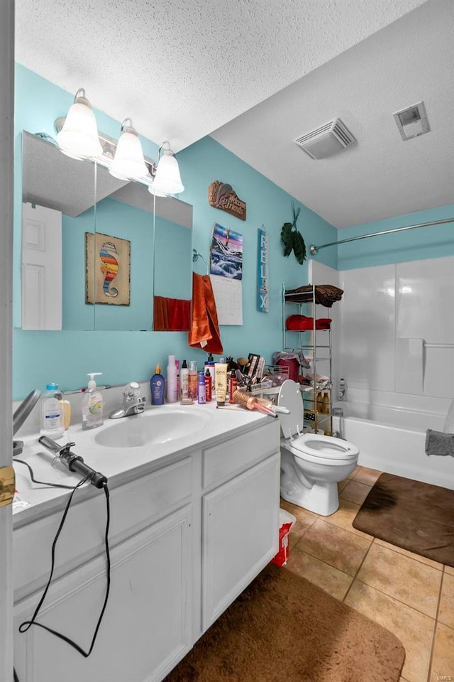 full bathroom with bathing tub / shower combination, vanity, a textured ceiling, tile patterned floors, and toilet