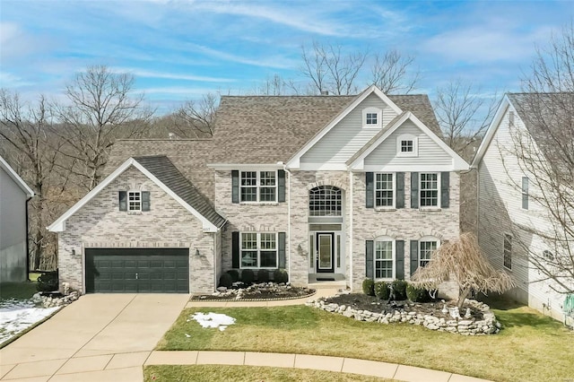 traditional-style home featuring a front lawn, concrete driveway, and brick siding