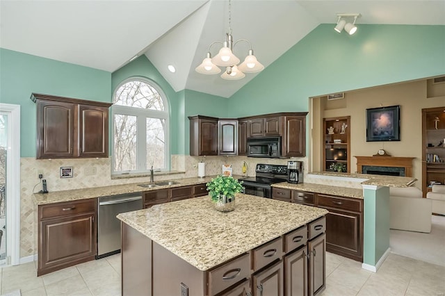 kitchen featuring open floor plan, a center island, dark brown cabinets, black appliances, and a sink