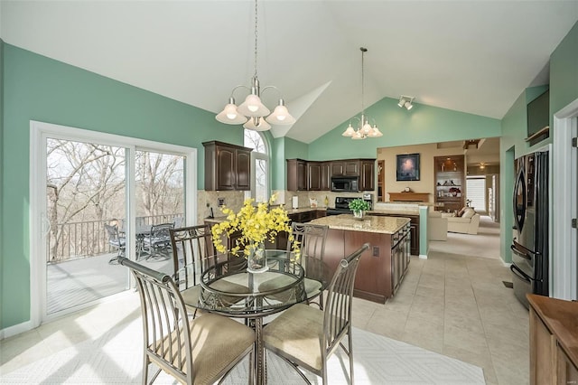 dining space featuring light tile patterned floors, high vaulted ceiling, and a notable chandelier