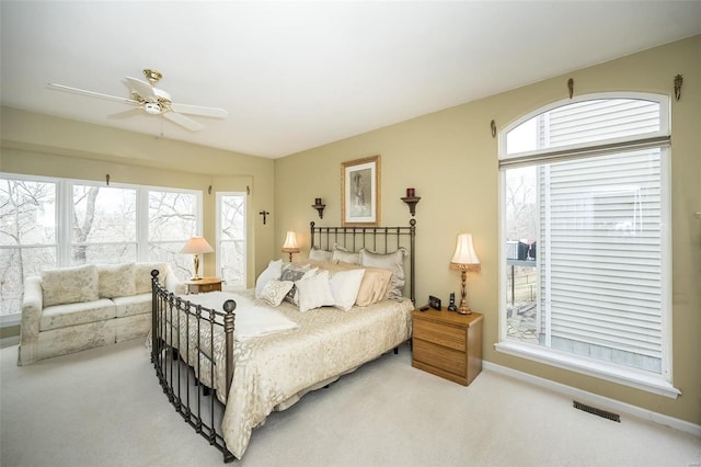 bedroom with ceiling fan, carpet floors, visible vents, and baseboards