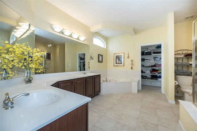 bathroom with visible vents, toilet, vanity, tile patterned flooring, and a bath