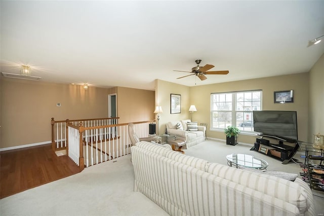 living room featuring carpet, ceiling fan, and baseboards