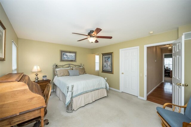 bedroom with carpet floors, baseboards, and a ceiling fan