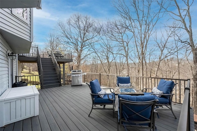 wooden terrace with stairs and an outdoor hangout area