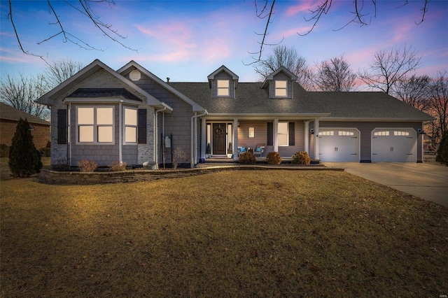 view of front of house featuring a garage and a lawn