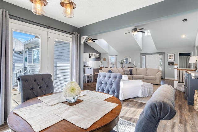 dining area with lofted ceiling, hardwood / wood-style floors, a textured ceiling, and ceiling fan