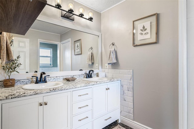 bathroom with vanity, a textured ceiling, and crown molding