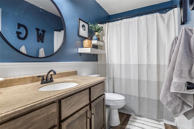 bathroom with vanity, hardwood / wood-style flooring, and toilet