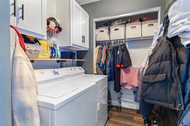 laundry area with cabinets, washer and dryer, and dark hardwood / wood-style flooring