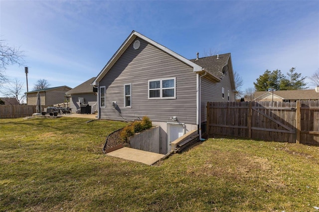 rear view of property featuring a lawn and a patio area