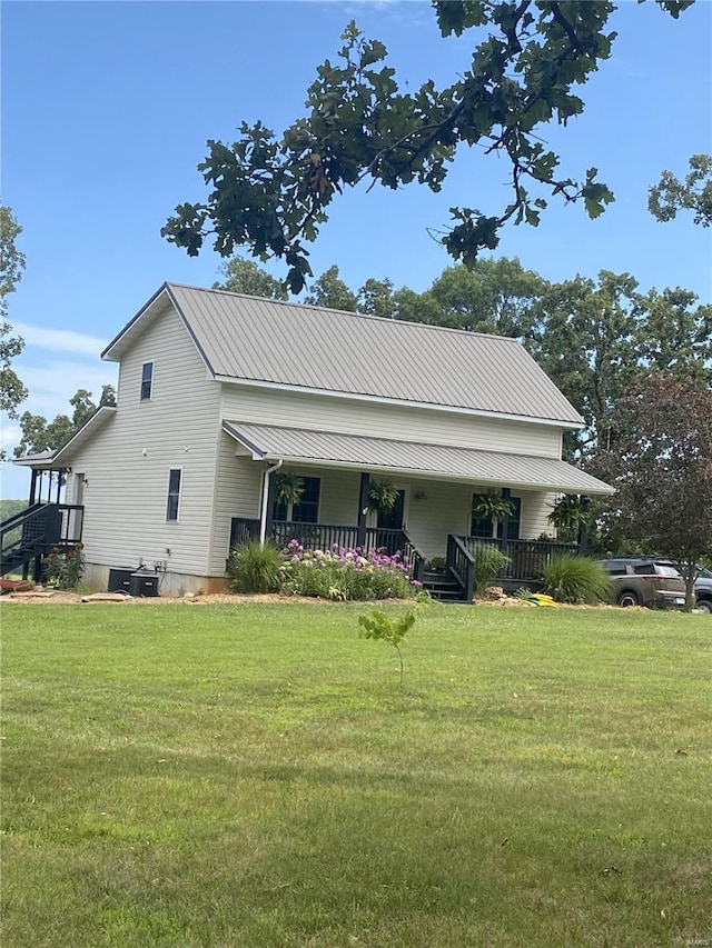 view of front of house with covered porch and a front lawn