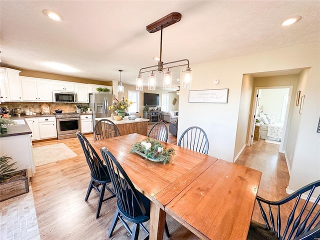 dining room featuring sink and light wood-type flooring