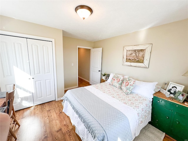 bedroom with hardwood / wood-style flooring and a closet