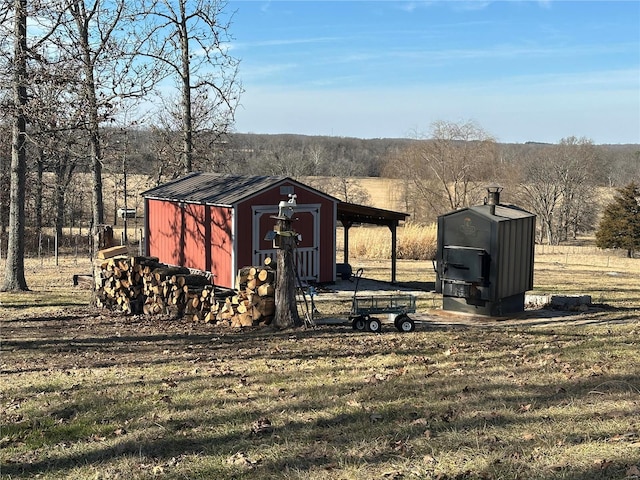 view of outdoor structure featuring a rural view and a yard