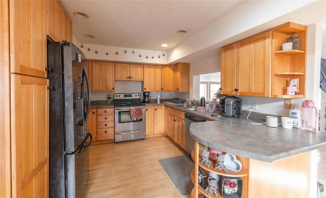 kitchen with sink, light wood-type flooring, kitchen peninsula, and appliances with stainless steel finishes