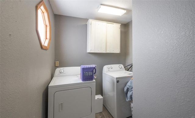 laundry area featuring cabinets and washer and dryer