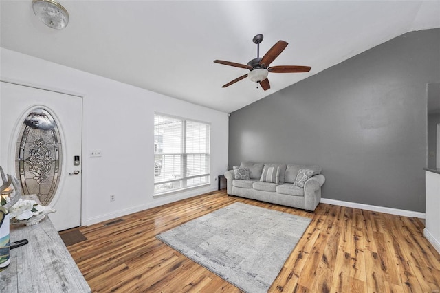 living room featuring ceiling fan, lofted ceiling, and hardwood / wood-style floors